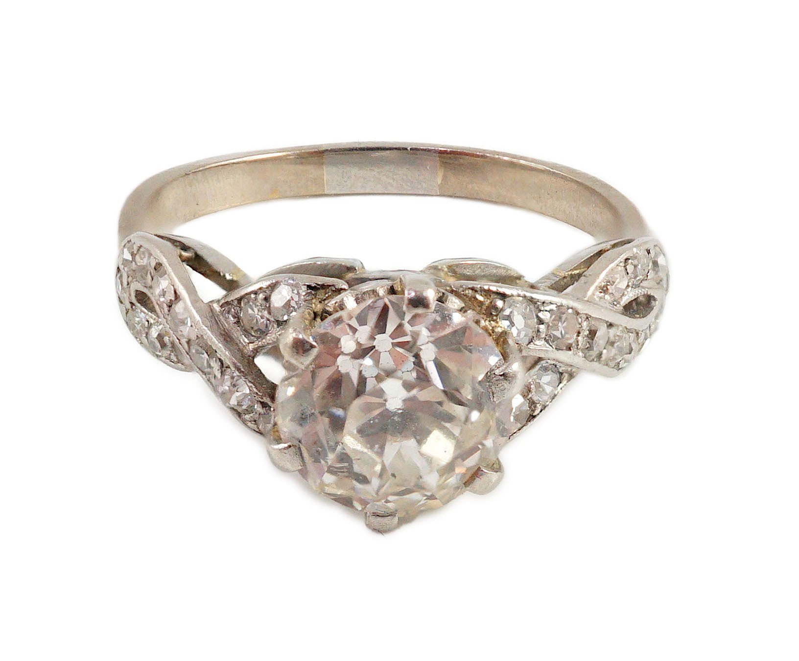 A mid 20th century white gold and single stone diamond ring, with diamond set crossover shoulders